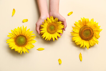 Woman with sunflowers on beige background © Pixel-Shot