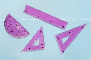 Set of transparent rulers on wooden backgroung, top view