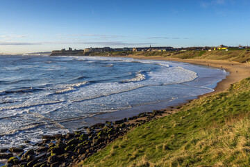 Long Sands beach at Tynemouth on a early spring morning, with Tynemouth Castle and Priory in the distance, Tyne and Wear.