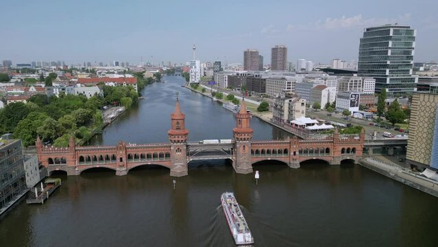 The drone aerial view of Oberbaum bridge across River Sprees, and view of Berlin city, Germany. The Oberbaum Bridge is a double-deck bridge crossing Berlin, Germany's River Sprees.