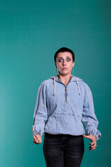 Portrait of frightened woman with short hair having nervous reaction during fashion shot in studio....