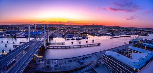 Gothenburg, Sweden - May 30, 2023: Sunset in the illuminated industrial Scandinavian city of Gothenburg, Sweden - high angle panorama view.