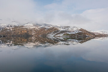 snowy mountains and blue sky with reflection in lake shot in winter season