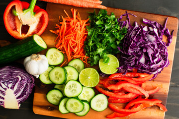 Variety of Fresh Vegetables Prepped for a Salad: Julienned carrots, shredded cabbage with sliced...