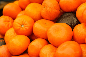 Showcase with tangerines. Food market.