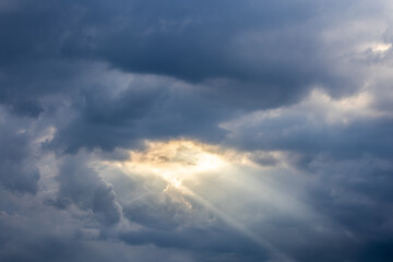 Sunrays through stormy clouds