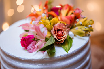 A flower arrangement decorating the top of a cake