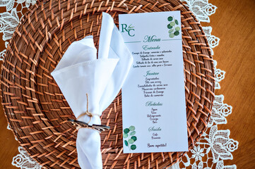 a sousplat on a table with a napkin and a decoration with the initials C & R