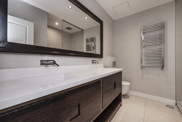 Bathroom with dark wood cabinet with drawers