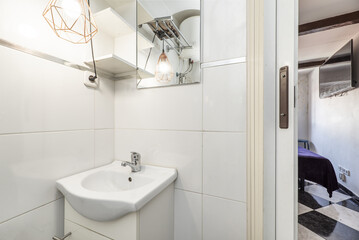 Small bathroom with a rectangular frameless mirror