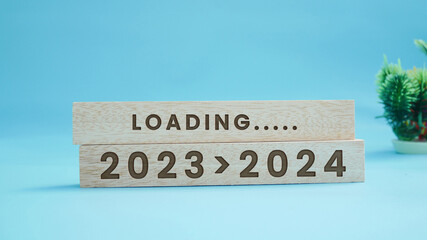 2024 New Year Loading. Loading bar with wooden blocks 2024 on blue background. Start the new year...