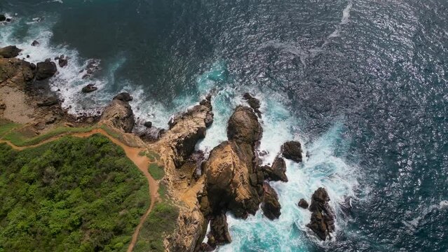 Aerial perspective, exploring of Punta Cometa's clifftop and rocks from above