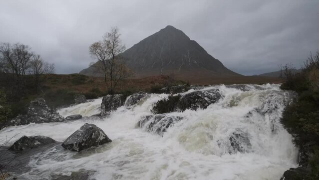 Footage of the mountain river and waterfall at the foot of Buachaille Etive Mor after heavy rain. Etive Mor Waterfall. Glencoe, Scotland
