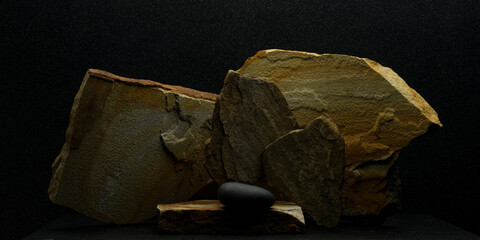 stone composition for product presentation.black zen stone and brown flat stones in still life for podium background