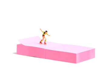 Creative miniature people toy figure photography. Sticky notes installation. A girl roller skater...