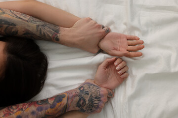 Passionate couple having sex on bed, closeup of hands