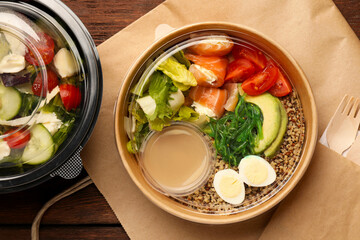 Tasty food in containers on wooden table, flat lay