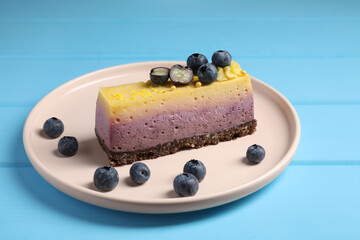 Delicious cheesecake with blueberry on light blue wooden table, closeup