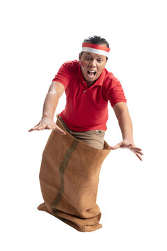Indonesian men celebrate Indonesian independence day on 17 August with a sack race