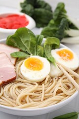 Delicious ramen with meat on table, closeup. Noodle soup