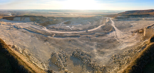 Aerial view of open pit mining site of limestone materials for construction industry with...