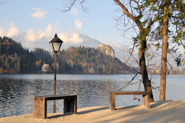 A Lamp Post And Wooden Benches On The Bled Island, Julian Alps, Slovenia