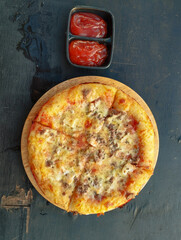 Pizza In Pleasure and spicy tomato sauce waiting on the table