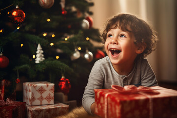 A happy young child opening christmas presents on Christmas day in front of a decorated tree
