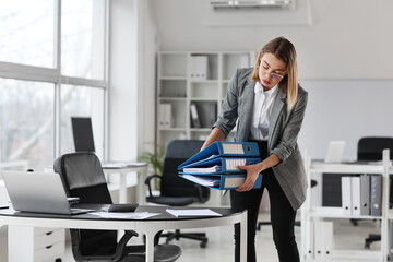 Female accountant with folders in office
