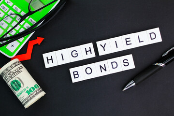 calculator, glasses and paper money with the alphabet word High-Yield Bonds.