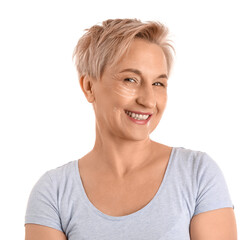 Mature woman with marked face for filler injection on white background, closeup