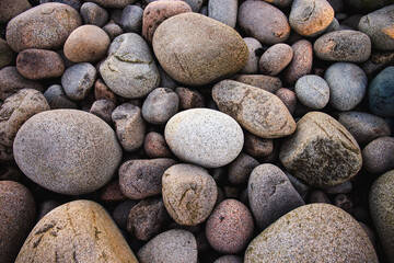 Smooth brown and grey cobblestones on a beach in Acadia, Maine