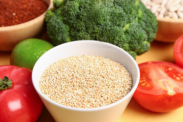 Different fresh vegetables and cereals on yellow background, closeup