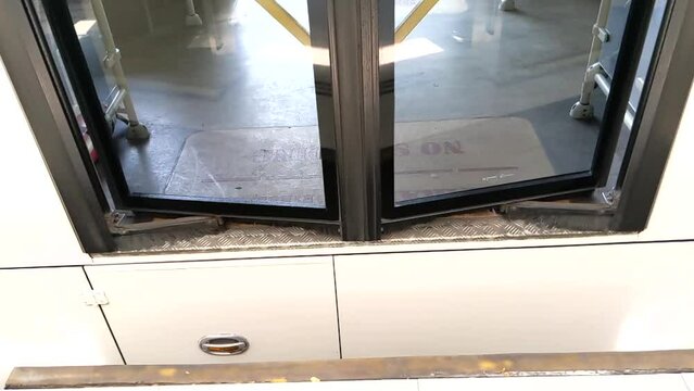 Slow motion. Automatic bus doors close at shelter stop