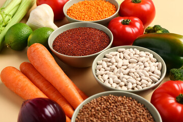 Different fresh vegetables and cereals on orange background