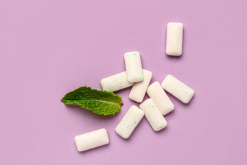Fresh chewing gums with mint on lilac background