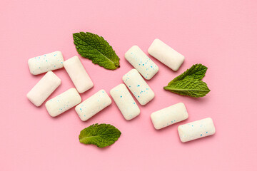 Fresh chewing gums with mint on pink background