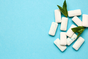 Fresh chewing gums with mint on blue background