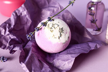 Crumpled paper with bath bomb with lavender flowers on color background, closeup