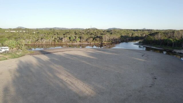 Tourists Stroll with Pets on Stumers Creek Dog Off Leash Area, Queensland, Australia Aerial Drone Shot