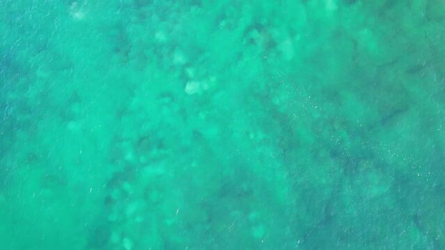 Foamy Waves at the Foot of Point Cartwright Lighthouse, Queensland, Australia Reveal Drone Shot