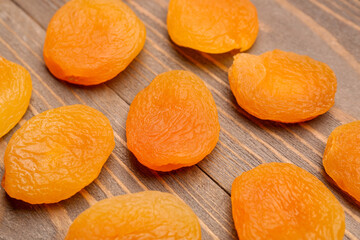Tasty dried apricots on wooden background