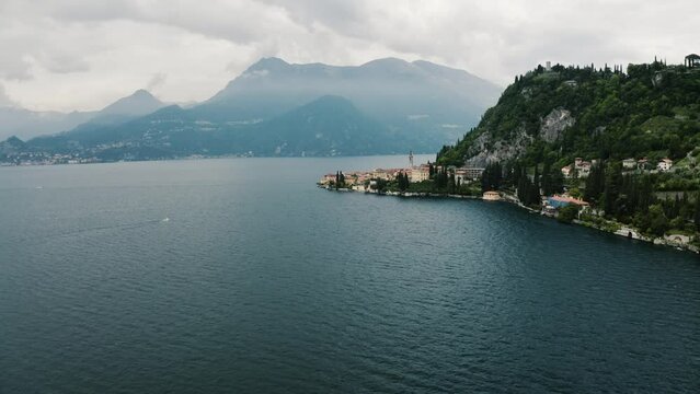 Aerial view pulling away from Varenna, Italy sitting on the side of Lake Como.