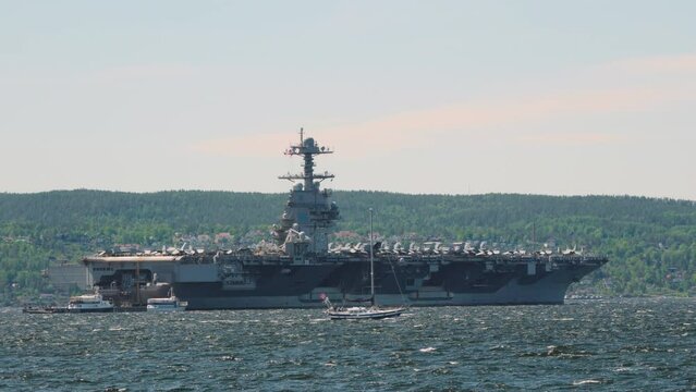 Military Ship USS Gerald Ford With Boats Sailing In Oslo Fjord In Norway. wide