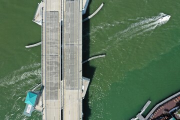 Drone photos of boats under a drawbridge.  John's Pass, Madeira Beach, Florida.