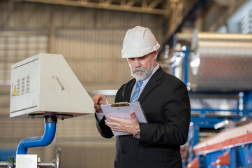 senior engineer manager boss bearded on face in white helmet and worker foreman survey check...