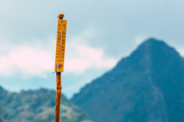 Thermometer on the top of mountain with 12 degree celsius.