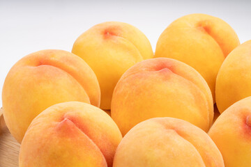 Yellow Peach with sliced on white Background, Fresh peach in wooden basket on white Background.