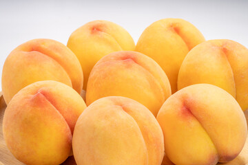 Yellow Peach with sliced on white Background, Fresh peach in wooden basket on white Background.