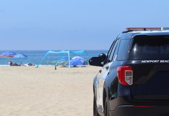 Closeup of police car on the beach. Police car background image. Police wallpaper. American police on the scene closeup.  © Noah